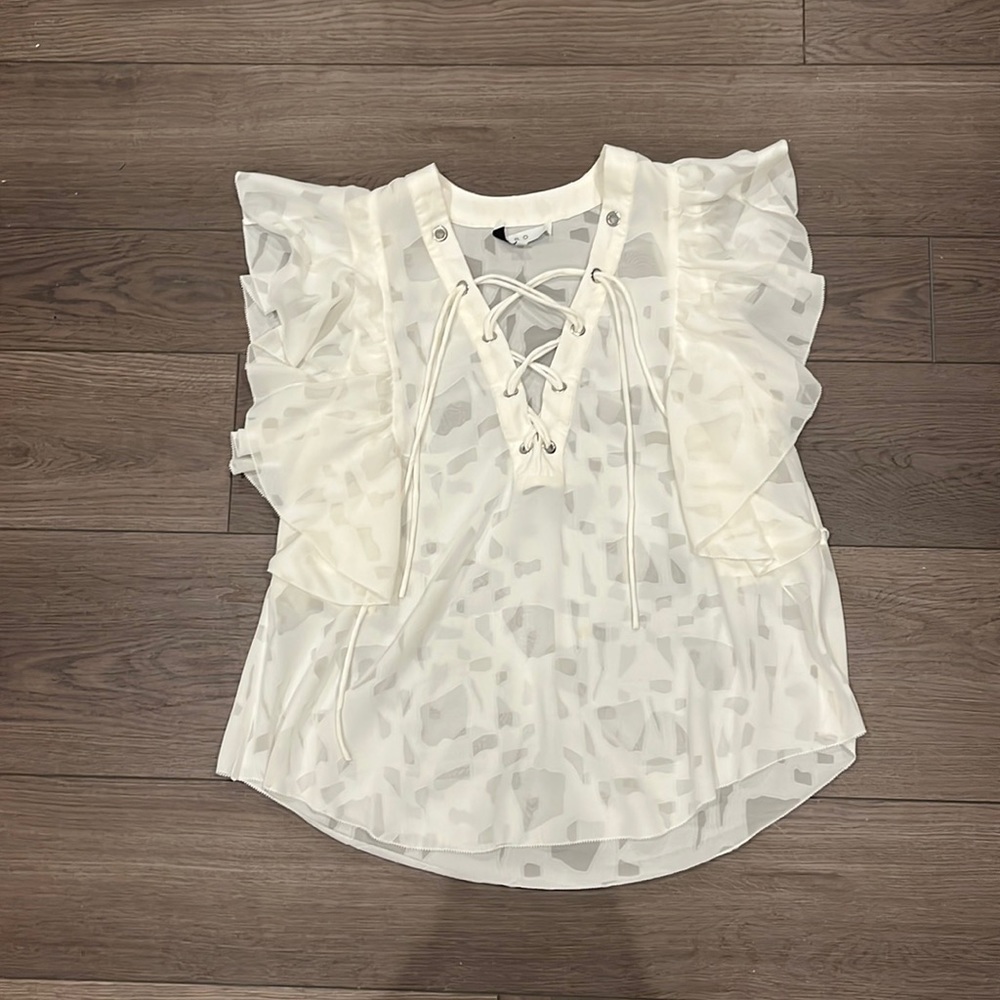 IRO white sheer blouse.  Lace up v-neck. Ruffle sleeves